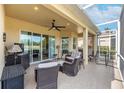 Outdoor patio area with seating and a grill at 1649 Emerald Dunes Dr, Sun City Center, FL 33573