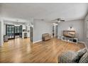 Bright and airy living room with hardwood floors and a view into the kitchen at 2104 W Okaloosa Ave, Tampa, FL 33604