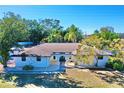 White single story home with a brown roof at 2142 Hickory Gate W Dr, Dunedin, FL 34698