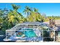 Screened-in rectangular pool with spa at 2142 Hickory Gate W Dr, Dunedin, FL 34698