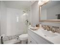 Modern bathroom with white vanity, walk-in shower, and pebble floor at 2424 W Tampa Bay Blvd # L102, Tampa, FL 33607