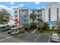 Exterior view of condo building, showcasing stairs and landscaping at 2424 W Tampa Bay Blvd # L102, Tampa, FL 33607