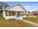 White bungalow with a covered porch and landscaping at 2860 4Th S Ave, St Petersburg, FL 33712