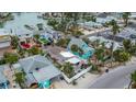 Aerial view showing a house's unique layout and close proximity to water and neighboring houses at 342 Boca Ciega Dr, Madeira Beach, FL 33708