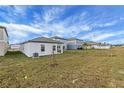 Spacious backyard with a large grassy area and new construction homes at 35605 Buttonweed Trl, Zephyrhills, FL 33541