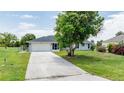 Front view of house with gray roof, driveway, and landscaping at 364 San Ambrosio St, Punta Gorda, FL 33983