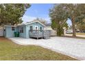 Side view of cute light blue house with a large patio at 5161 Rena N St, St Petersburg, FL 33709