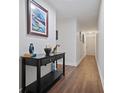 Bright entryway with hardwood floors and console table at 5750 80Th St N # B106, St Petersburg, FL 33709