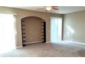 Spacious living room with built-in shelving and sliding doors at 6769 Breezy Palm Dr, Riverview, FL 33578