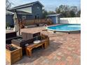 Round pool with patio furniture and wooden deck at 7336 Orchard Dr, Wesley Chapel, FL 33545