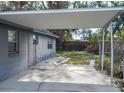 Covered carport area adjacent to the house at 7607 Lavender Ln, Tampa, FL 33619