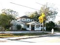 Two-story house with gray brick, palm tree, and a paved driveway at 8006 N Rome Ave, Tampa, FL 33604