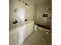 Bathroom with double vanity, marble shower, and black fixtures at 8206 N Marks St, Tampa, FL 33604