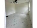 Bright bedroom with ceiling fan and marble flooring at 8206 N Marks St, Tampa, FL 33604