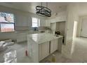 Modern kitchen with white cabinets and marble countertops at 8206 N Marks St, Tampa, FL 33604