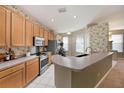 Modern kitchen with stainless steel appliances and light wood cabinets at 10010 Bucklin St, Tampa, FL 33625