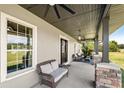 Covered porch with seating area and ceiling fan at 11307 Wagon Trail Run, Lithia, FL 33547