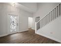 Bright entryway with hardwood floors, elegant door, and staircase at 11614 Brighton Knoll Loop, Riverview, FL 33579