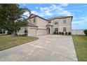 Two-story house with a three-car garage and landscaped yard at 11614 Brighton Knoll Loop, Riverview, FL 33579