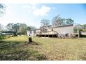 Spacious backyard with green grass and a small storage shed at 1236 Live Oak Ln, Lutz, FL 33558