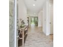 Bright and airy entryway with tile floors and a console table at 14690 Horse Trot Rd, Lithia, FL 33547