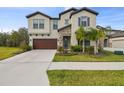 Two-story home with stone accents and a three-car garage at 14690 Horse Trot Rd, Lithia, FL 33547