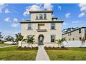 Two-story house with light beige siding, gray door, and walkway at 1740 W Saint Louis St, Tampa, FL 33607