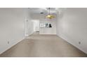 Spacious living room with view into the kitchen at 2375 Lake Heather Heights Ct # 202, Dunedin, FL 34698