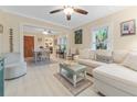 Bright living room with L-shaped sofa, light flooring, and views to dining area at 2545 2Nd N Ave, St Petersburg, FL 33713