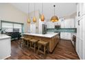 Modern kitchen featuring white cabinets, quartz countertops, and an island at 2893 Allapattah Dr, Clearwater, FL 33761