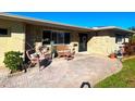 Inviting front porch with wicker furniture and brick pavers at 3182 65Th N St, St Petersburg, FL 33710