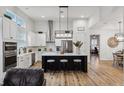 Open concept kitchen with white cabinets and island at 3809 Lajuana Blvd, Wesley Chapel, FL 33543