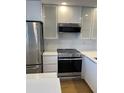 Stainless steel appliances and white shaker cabinets in kitchen at 391 Airport E Ave # 403, Venice, FL 34285