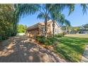 Side view of the house, showcasing the garage and driveway at 530 Ponce De Leon Blvd, Belleair, FL 33756