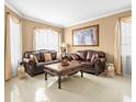 Spacious living room with leather couches and ornate coffee table at 5537 Terrain De Golf Dr, Lutz, FL 33558