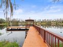 Wooden dock with gazebo over calm lake water at 5649 Glencrest Blvd, Tampa, FL 33625