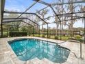 Inviting screened-in pool area overlooking a tranquil lake at 5649 Glencrest Blvd, Tampa, FL 33625