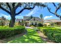 House exterior showcasing landscaping and large tree at 6120 Watercolor Dr, Lithia, FL 33547