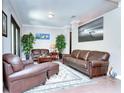 Living room featuring leather sofas and hardwood floors at 6120 Watercolor Dr, Lithia, FL 33547