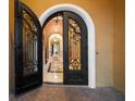 Ornate double-door entry with decorative ironwork leading into the home at 6408 Bright Bay Ct, Apollo Beach, FL 33572