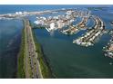 Aerial view showcasing waterfront homes and road at 690 Island Way # 410, Clearwater Beach, FL 33767