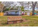 Stone bench with 'Tanglewood' and a view of the house at 7000 Dr Martin Luther King Jr S St, St Petersburg, FL 33705