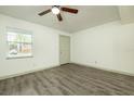 Grey vinyl flooring, neutral walls, and a ceiling fan at 7117 E Bank Dr # 2, Tampa, FL 33617