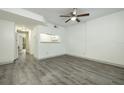 Bright living room with grey vinyl flooring and a kitchen pass-through at 7117 E Bank Dr # 2, Tampa, FL 33617