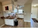 Updated kitchen with wood countertops and white cabinets at 7400 Spring Hill Dr # 209, Spring Hill, FL 34606