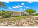 Tan single-story house with a two-car garage and mature landscaping at 1085 Indian Rocks S Rd, Largo, FL 33770