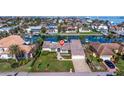 Bird's eye view of waterfront property showcasing canal access and neighborhood at 127 Sands Point Dr, Tierra Verde, FL 33715