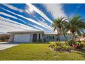 Charming Florida home with palm trees and spacious yard at 1290 Cambridge Dr, Venice, FL 34293