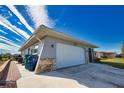 House exterior showcasing garage and brick walkway at 1290 Cambridge Dr, Venice, FL 34293