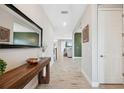 Spacious entryway with tile floors, a console table, and mirror at 14786 Horse Trot Rd, Lithia, FL 33547